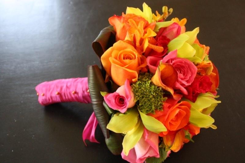 Cymbidium Orchids, orange roses, orange mini Callas, deep pink and medium pink roses, orange mini orchids, green hydrangea, bridal bouquet