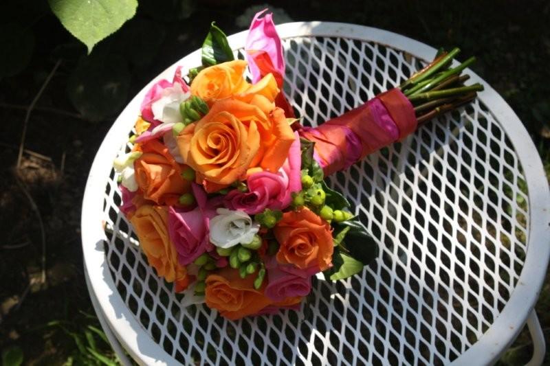 We created a bridal bouquet of white Lily orange and pink Roses