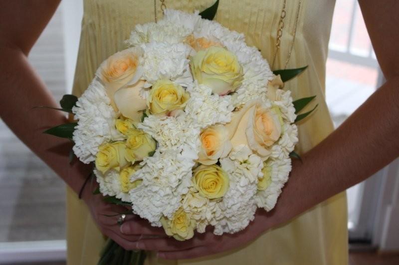 The maids wore butter cream yellow dresses and the bouquets were so sweet