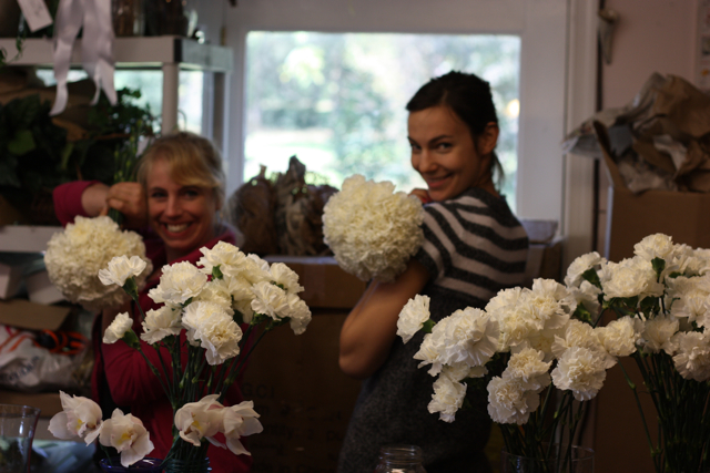 Here the girls are creating white carnation bouquets