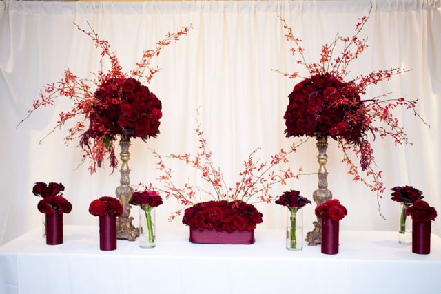 These lovely centerpieces of red orchids red roses and red carnations