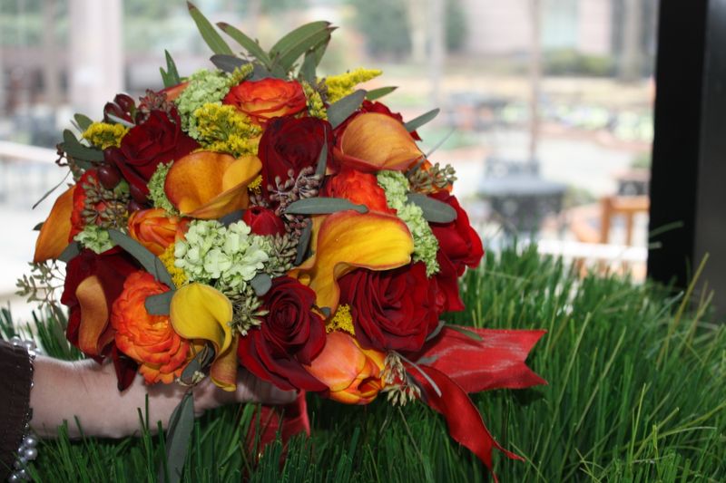 orange callas, circus roses, black magic roses, hypericum berry, seeded eucalyptus, green viburnum, red tulips, orange tulips