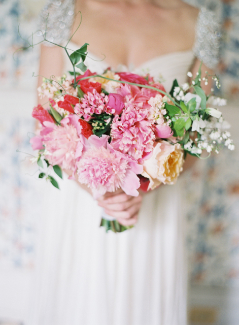 Bridal bouquet by designer Donna Sue Roberts, First Dance Floral - Southern Maryland, with coral godetia, pink peonies, peach garden roses, pink bouvardia, peach stock and sweet pea tendrils