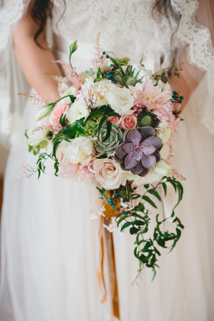 Cascading bridal bouquet by designer Courtenay Lambert of Courtenay Lambert Florals - Cincinnati, Ohio, with succulents, café au lait dahlias, Quicksand roses, Star Blush spray roses, blush astilbe, eryngium, hellebores, white lisianthus, jasmine vine and porcelain berry