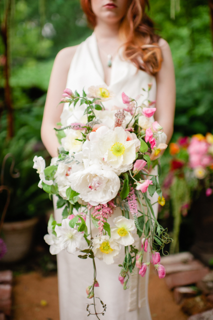 Cascading bridal bouquet by Designer Carmel Vandale of Mt. Lebanon Floral - Pittsburg, Pennsylvania, with white peonies, white poppies, white clematis, blush astilbe, blush sweet pea and blush veronica