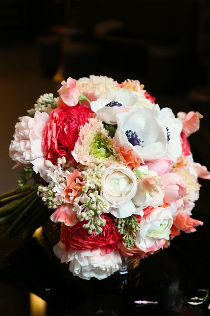 Bridal bouquet by designer Jennifer Ederer of Modern Day Floral - Grand Rapids, MI, with coral ranunculus, coral sweet pea, blush ranunculus, white lilacs, white ranunculus and black and white anemones