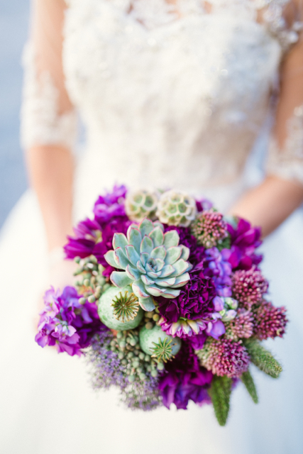 bridal bouquet by designer Sharon Duke of Isn't She Lovely Florals – Florida, with succulents, poppy pods, purple carnations, bullet allium, stock and scabiosa pods