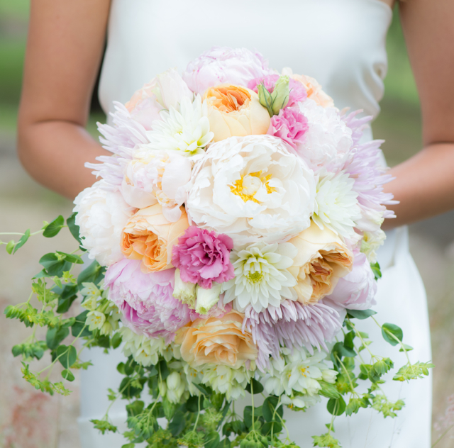 Bridal bouquet by designer Lisa Almeida of Blossoms of Hawaii - Wailuku, Maui, Hawaii, with white and pink peonies, pink lisianthus, white dahlias, Juliet garden roses and bupleurum