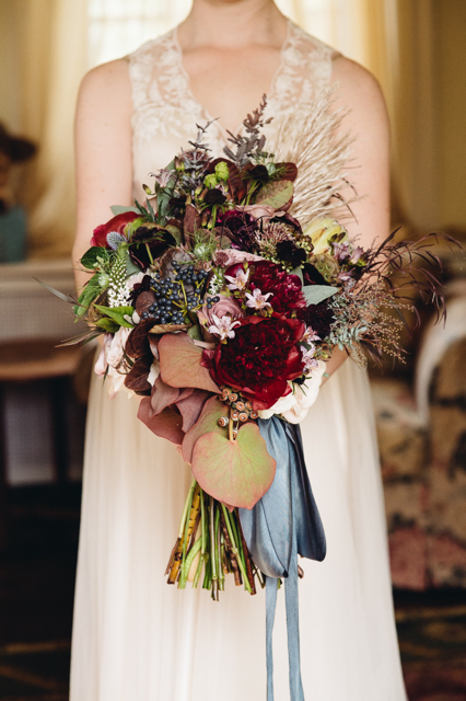 dark toned Bridal bouquet by designer Cynthia Manchester of Oleander Florals and Events - New Jersey, with burgundy peonies, acacia foliage, agonis, viburnum berries, white veronica and amnesia roses