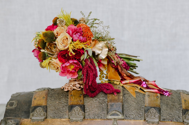 Cascading bridal bouquet by designer Dawn Kelly of Soiree Floral – Nantucket, Massachusetts, with Echinacea, coral dahlias, orange cockscomb, nude roses, yellow feather celosia, dark pink garden roses, pieris buds, gold scabiosa pods, gold succulents, red hanging amaranthus, seeded eucalyptus and cascading vintage ribbons