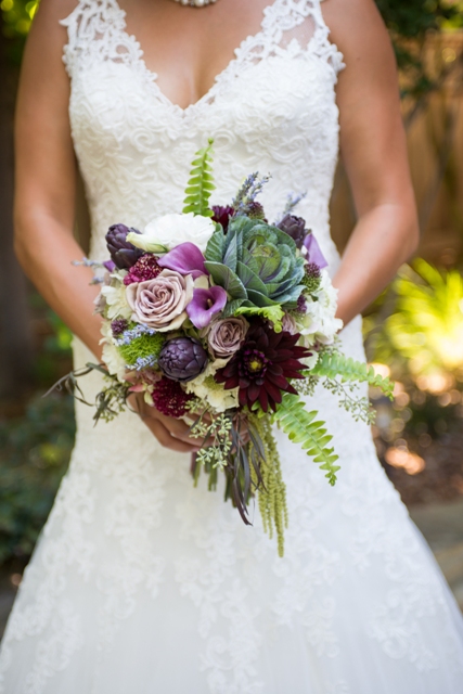 Bridal bouquet by designer Kristi Landphere of The Posh Posey - Folsom, CA, with purple artichokes, burgundy dahlias, kale, fuschia mini callas, amnesia roses, bullet allium, seeded eucalyptus, agonis, ivory lisianthus, white scabiosa, lavender, fern and hanging amaranthus