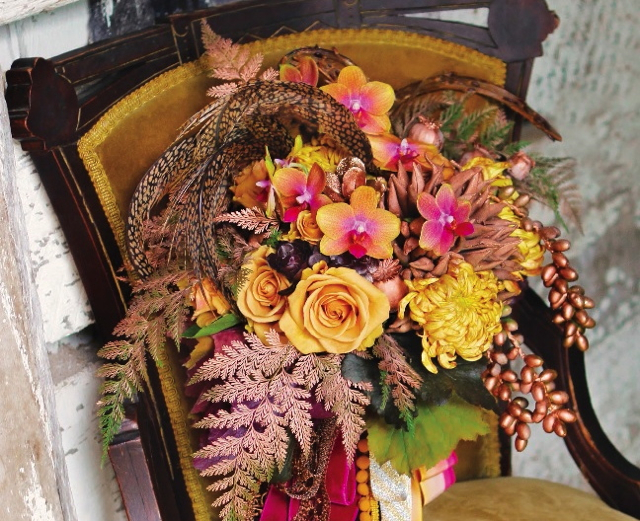 Bridal bouquet by designer Stacy Ercan from Stacy K Florals - Rochester, NY, with gold roses, gold and pink phalaenopsis orchids, football mums, copper fern, copper dates, pheasant feathers and cascading ribbon