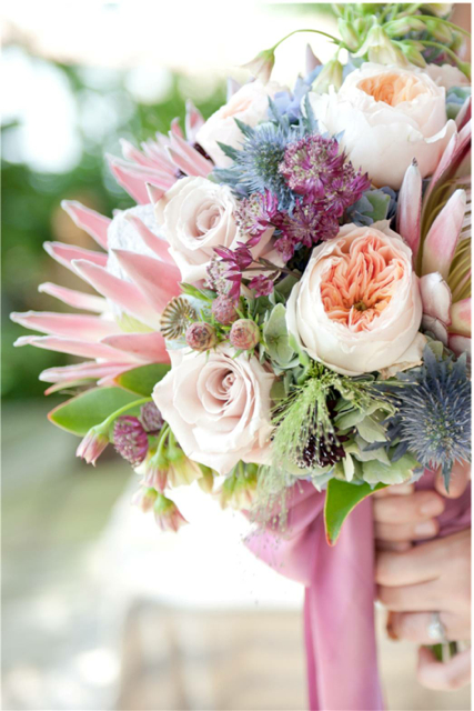 Bridal bouquet by designer Isha Foss of Isha Foss Events - Virginia Beach, Virginia, with king protea, Juliet garden roses, poppy pods, Quicksand roses, leucadendron, burgundy astrantia, green hydrangea, thistle and allium