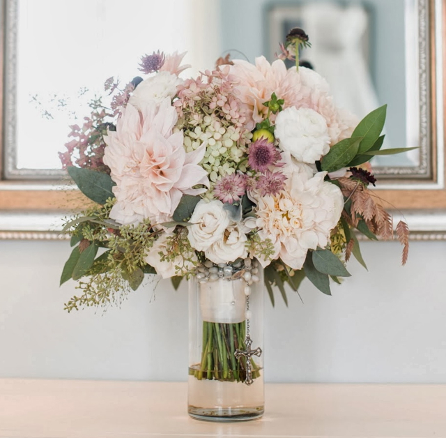 Bridal bouquet by designer Corinne Sebesta Sisti of Sebesta Design LLC – Narbeth, Pennsylvania, with hydrangea, café au lait dahlias, white ranunculus, astrantia, northern sea oats and seeded eucalyptus