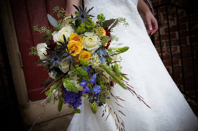 Cascading bridal bouquet by Designers Peggy and Hunter Sherwood of Sherwood Events - Lexington, Kentucky, with blue hydrangea, delphinium, thistle, star of Bethlehem, white roses, yellow spray roses, bupleurum, seeded eucalyptus, chamomile and native grasses