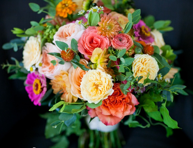 Bridal bouquet by designer Heather Potter of Cottage Flowers - Malvern, Pennsylvania, with Free Spirit roses, Juliet garden roses, coral roses, orange dahlias, fuchsia zinnias and orange gomphrena 