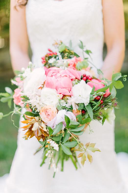 Bridal bouquet by designer Sherry Donnelly from Gertie Mae's Floral Studio - Atlanta, Georgia, with Coral Charm peonies, peach ranunculus, hypericum berries and passion vine