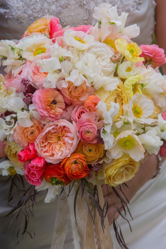 Bridal bouquet by designer Victoria Clausen of Victoria Clausen Floral Events – Reisterstown, Maryland, with white sweet peas, white and yellow poppies, yellow garden roses, peach ranunculus, Juliet garden roses, coral godetia, sarracenia and agonis