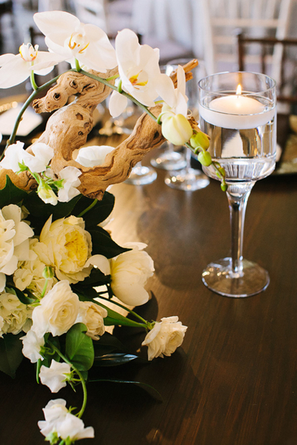 centerpiece with candlelight, white flower arrangement