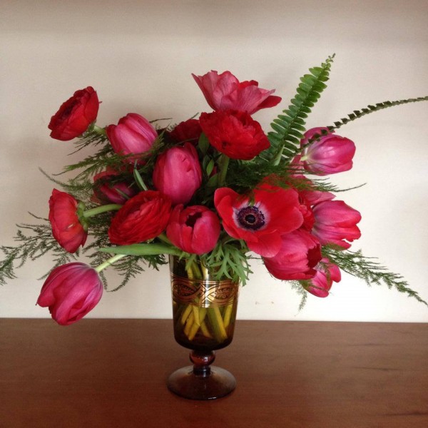 red tulips anemones fern in footed vase primrose floral event design chapel designers